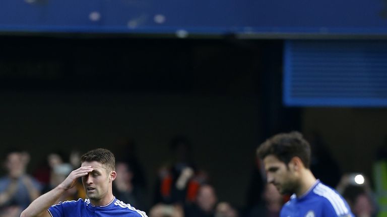 Chelsea's English defender Gary Cahill (L) and Chelsea's Spanish midfielder Cesc Fabregas 