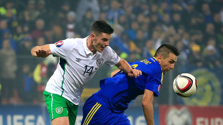 Vedad Ibisevic (R) of Bosnia is challenged by Ciaran Clark (L) of the Republic of Ireland during the Euro 2016 play-off first-leg.