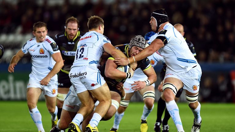 Dan Lydiate runs into Exeter Chiefs' Sam Hill and Mitch Lees