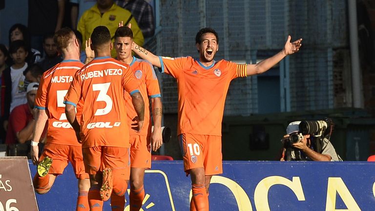 Valencia's midfielder Dani Parejo (R) celebrates after scoring a goal against Celta Vigo
