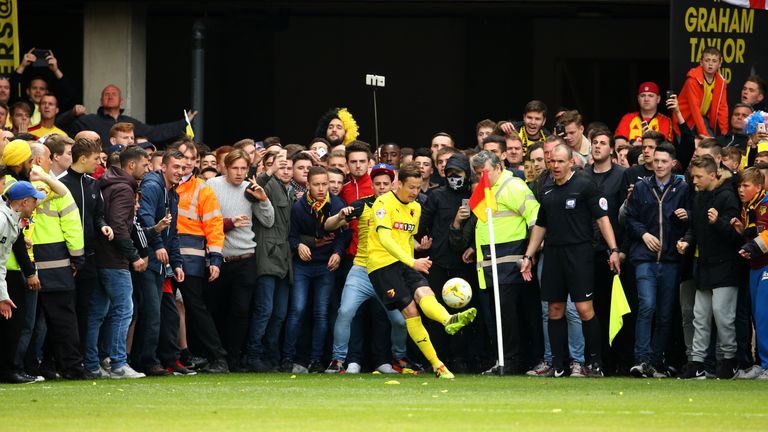 Daniel Tozser tries to take a corner as fans wait to invade the pitch at the Championship match between Watford and Sheff Wed at Vicarage Road in May 2015