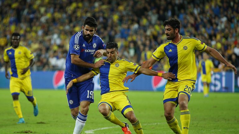 Diego Costa of Chelsea challenges for the ball with Omri Ben Harush (R) and Avraham Rikan of Maccabi Tel-Aviv 