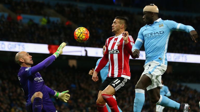 Dusan Tadic of Southampton and Willy Caballero of Manchester City compete for the ball 