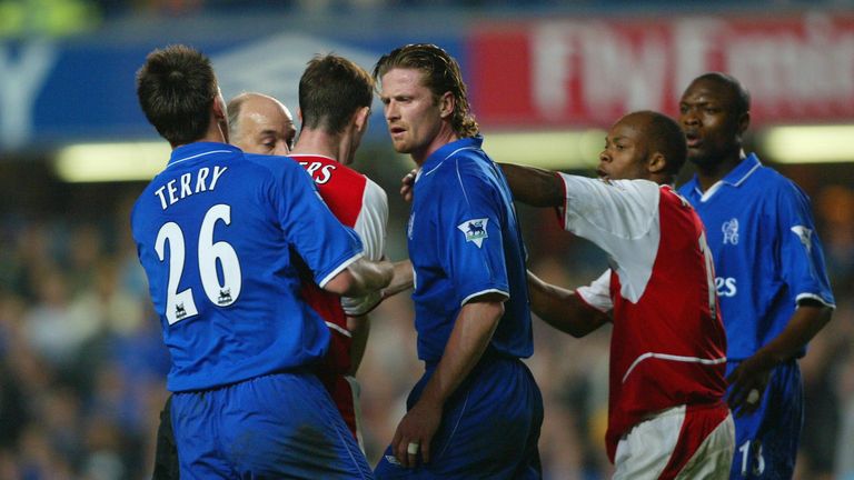 LONDON - MARCH 25:  Francis Jeffers of Arsenal goes head to head with Emmanuel Petit of Chelsea during the FA Cup Quarter Final Replay  in March 2003