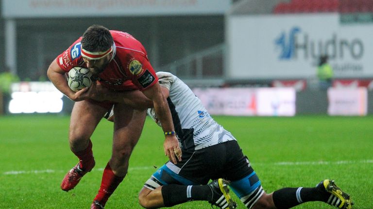 Scarlets' Emyr Phillips is tackled by Zebre's Dries van Schalkwyk