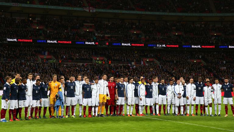 Players pose for a moment of applause prior to the International Friendly match between England and France at Wembley Stadium