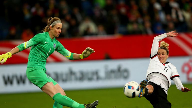 Anja Mittag of Germany (R) challenges Karen Bardsley of England (L)