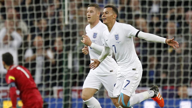 England's midfielder Dele Alli (R) celebrates scoring his team's first goal during the friendly football match between England and France at Wembley