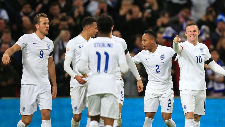 England's Wayne Rooney celebrates scoring his sides second goal of the match with team-mates during the international friendly match at Wembley Stadium