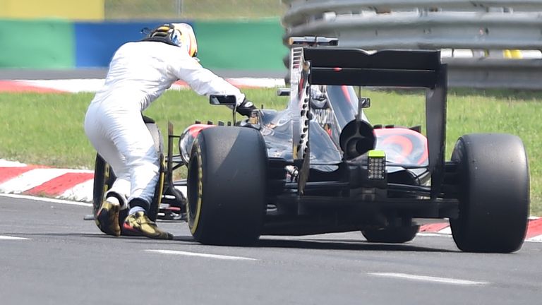 How the mighty have fallen: Fernando Alonso pushes his McLaren back to the pits during qualifying in Hungary - Picture by Andrej Isakovic, Getty Images