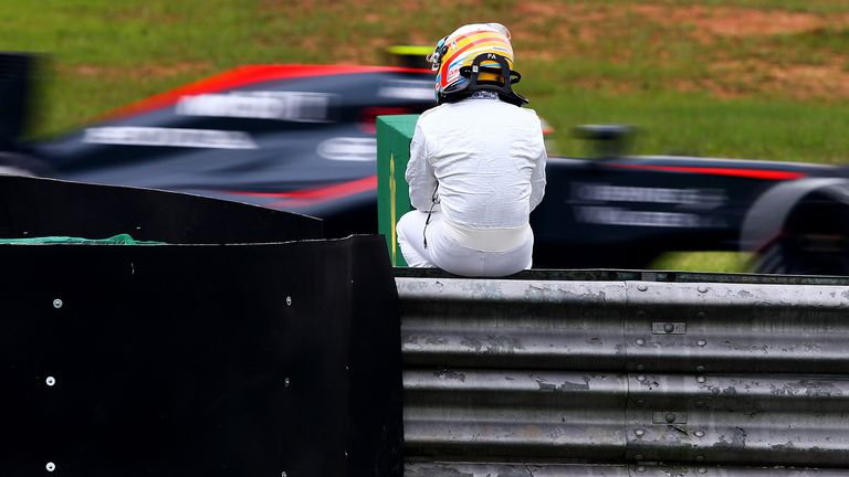 Sitting it out: Fernando Alonso watches his team-mate in action after his McLaren broke down in practice at Brazil - Picture by Clive Mason, Getty Images