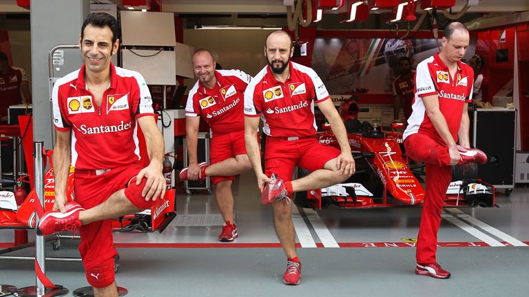 On the stretch: Ferrari mechanics warm up for their pit stop practice ahead of the Singapore GP - Picture by Mirko Stange, Sutton Images