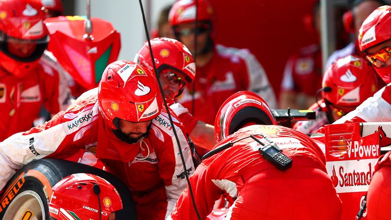 The men in red: Kimi Raikkonen's pit crew execute a change of tyres during the Malaysia GP - Picture by Mark Thompson, Getty Images