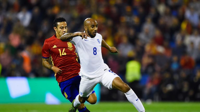 Fabian Delph of England is chased by Thiago Alcantara of Spain 