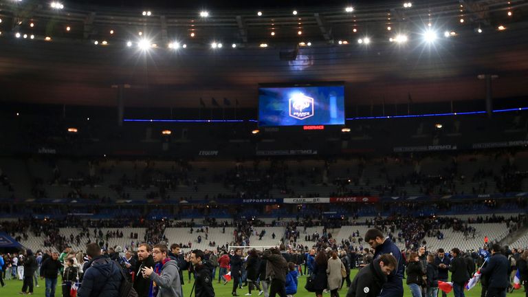 Fans on the pitch at the Stade de France after news of explosion's in Paris broke.