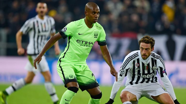 Fernandinho of Manchester City controls the ball as Claudio Marchisio of Juventus closes in