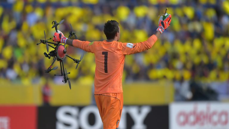 Uruguay's Fernando Muslera retrieves a drone that fell on the pitch in WC Qualifier against Ecuador (Pic: Rodrigo Buendia/AFP/Getty Images)