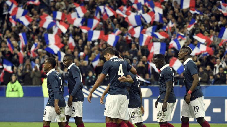 France's players celebrate after opening the scoring during a friendly international football match between France and Germany