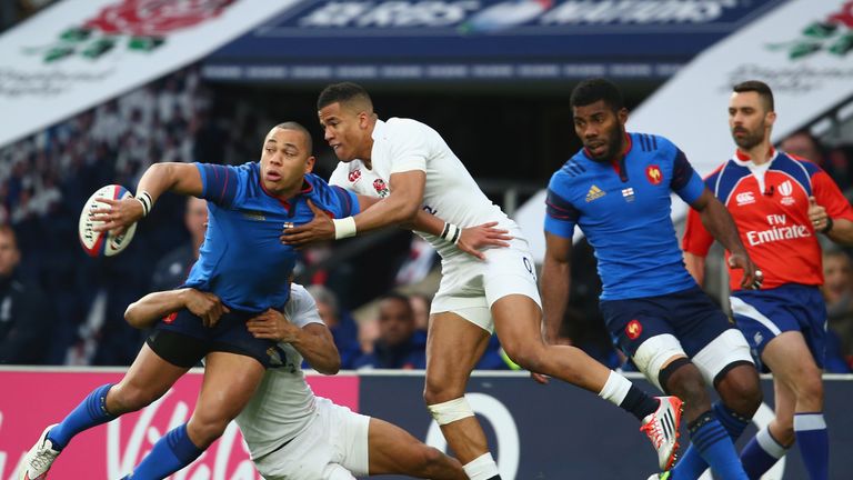 Gael Fickou of France offloads as Anthony Watson of England challenges during the RBS Six Nations