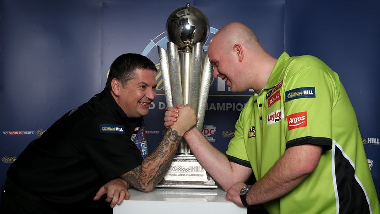 Michael van Gerwen and Gary Anderson pose with the Sid Waddell trophy during a William Hill World Darts Championships media event