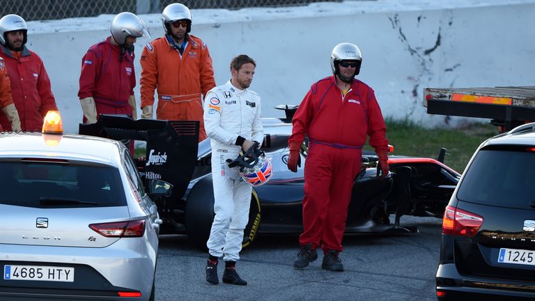 Starting as they would go on: Jenson Button is given a lift back to the pits after his McLaren car breaks down in testing - Picture by Sutton Images