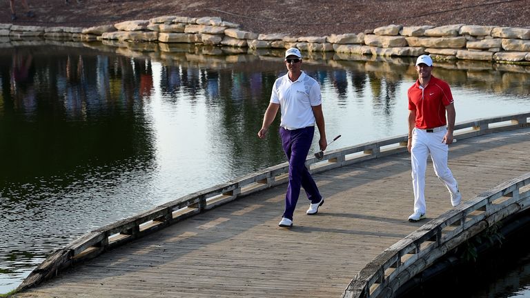 DUBAI, UNITED ARAB EMIRATES - NOVEMBER 20:  Henrik Stenson of Sweden and Rory McIlroy of Northern Ireland make their way on to the 17th green during the fi