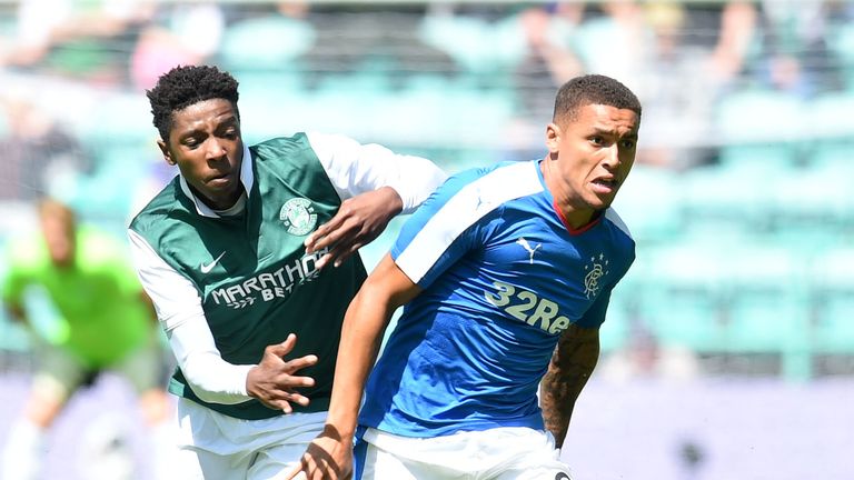 Hibernian's Dominique Malonga (left) is held off by Rangers' James Tavernier (right)