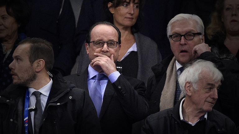 French President Francois Hollande (C) and Germany's Foreign Minister Frank-Walter Steinmeier (R) attend a football match between France and Germany.