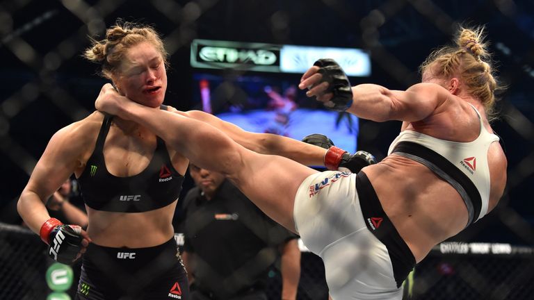 Holly Holm of the US (R) lands a kick to the neck to knock out compatriot Ronda Rousey and win the UFC title fight in Melbourne on November 15, 2015. 