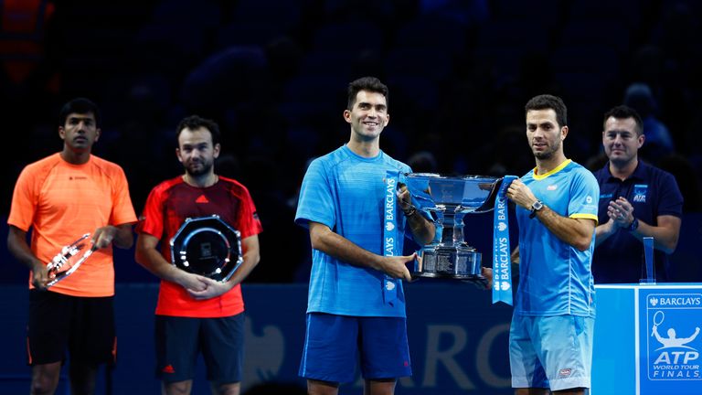 LONDON, ENGLAND - NOVEMBER 22:  (L-R) Horia Tecau of Romania and Jean-Julien Rojer of France lift the trophy following their victory during the men's doubl