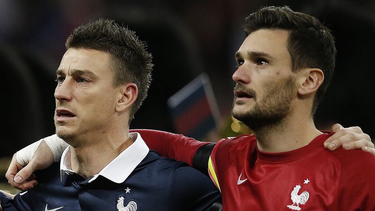 France's goalkeeper and captain Hugo Lloris (R) and defender Laurent Koscielny sing their country's national anthem before their game against England