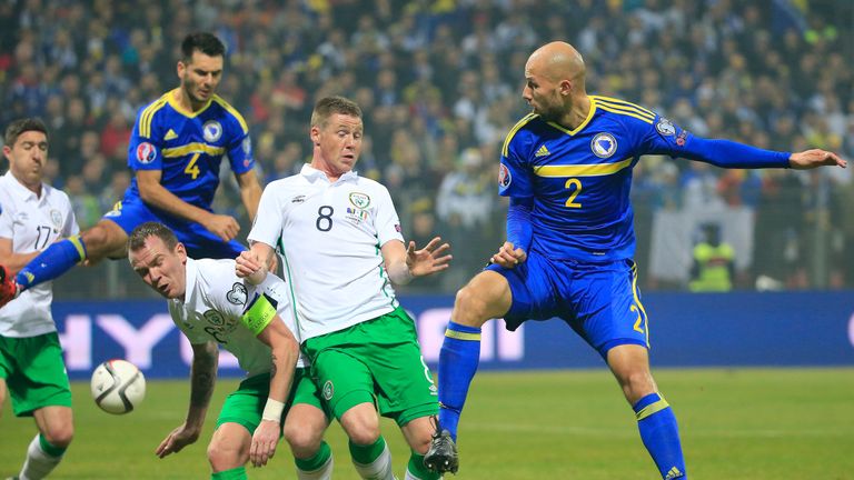 Edin Cocalic (R) of Bosnia in action against James McCarthy (C) and Glenn Whelan (L) of Ireland