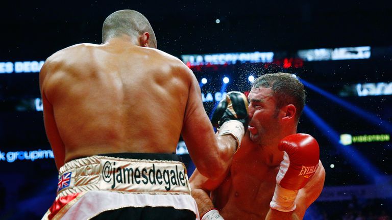 QUEBEC CITY, QC - NOVEMBER 29: James Degale of England throws a punch to Lucian Bute of Canada during their IBF super-middleweight championship fight at th