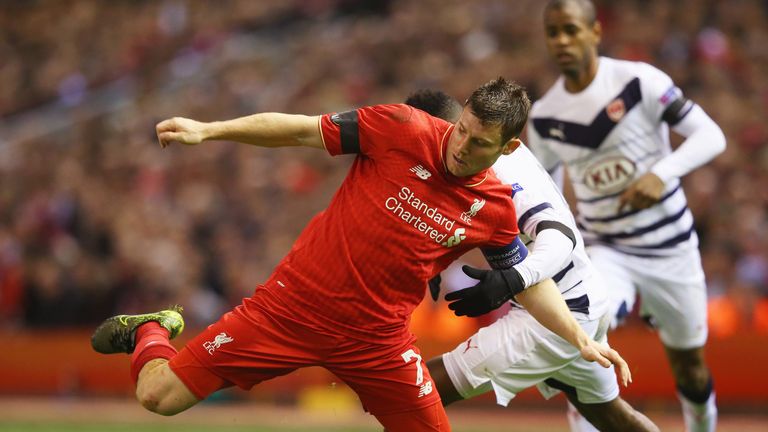 LIVERPOOL, ENGLAND - NOVEMBER 26:  James Milner of Liverpool holds off Andre Biyogo Poko of Bordeaux during the UEFA Europa League Group B match between Li