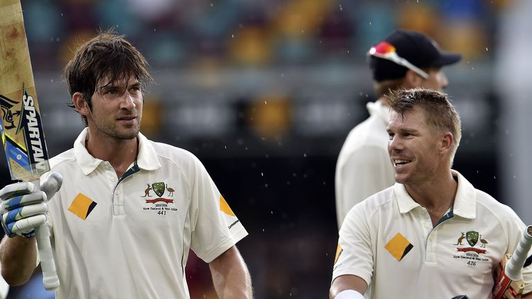 Australia's Joe Burns (L) celebrates his 100 runs as teammate David Warner looks on during day three of the first Test
