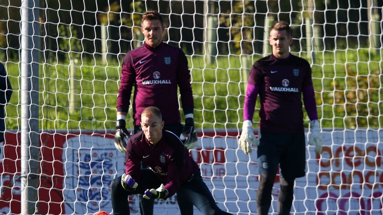 BURTON-UPON-TRENT, ENGLAND - OCTOBER 08:  Joe Hart of England makes a save as Jack Butland and Tom Heaton look on during the England training session at St