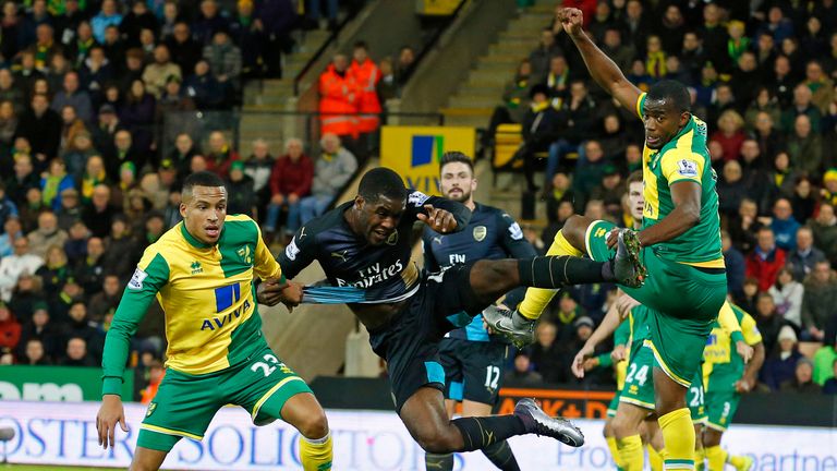 Arsenal's Joel Campbell (2nd L) vies with Norwich City's Martin Olsson (L) and Sebastien Bassong