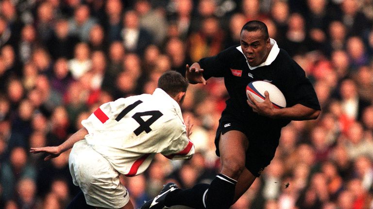 All Black Jonah Lomu prepares to fend off England's David Rees