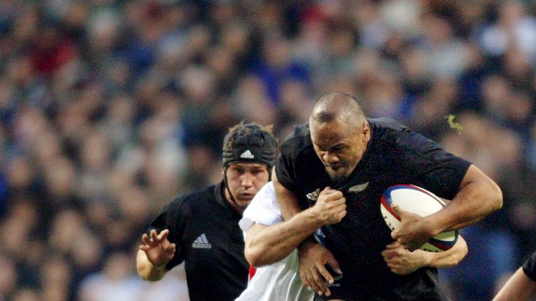 New Zealand's Jonah Lomu (R) runs over England's Neil Back (bottom) in 2002. England won the game 31-28.