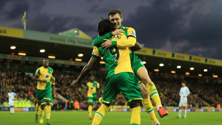 Jonny Howson (R) of Norwich City celebrates scoring his team's first goal with his team mate Dieumerci Mbokani (L) during the match against Swansea