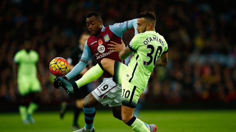 Jordan Ayew (l) tussles with Nicolas Otamendi during Aston Villa's clash with Manchester City