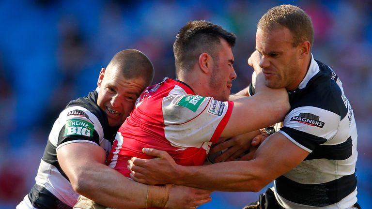 MANCHESTER, ENGLAND - MAY 25:  Jordan Cox (C) of Hull KR is tackled by Mark O'Meley (L) and Daniel Holdsworth of Hull FC during the Super League Magic Week