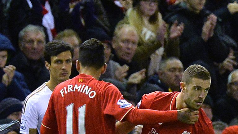 Liverpool's Jordan Henderson (right) comes on for Roberto Firmino against Swansea