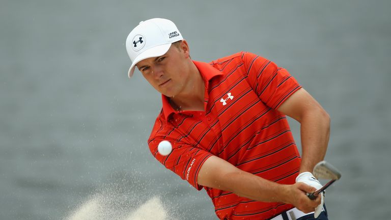 Jordan Spieth splashes out of a bunker at the fourth hole, on day three in Sydney