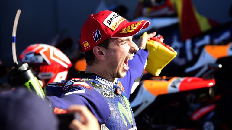 Movistar Yamaha's Spanish rider Jorge Lorenzo celebrates winning the race and the 2015 MotoGP world championship tiltle