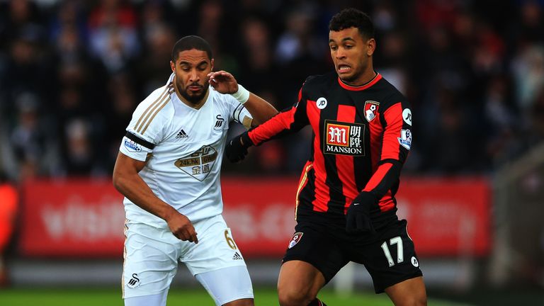 Josh King holds off a challenge from Ashley Williams 