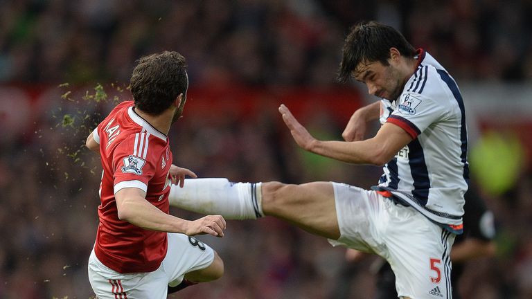 Juan Mata (L) vies with  midfielder Claudio Yacob during the English Premier League football match between Manchester United and West Bromwich Albion