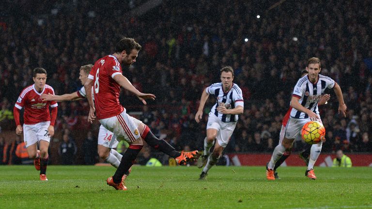 Manchester United's Spanish midfielder Juan Mata shoots from the penalty spot to score his team's second goal