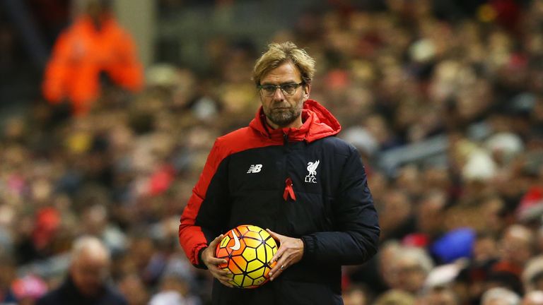 Liverpool manager Jurgen Klopp holds the match ball during the Premier League match with Swansea