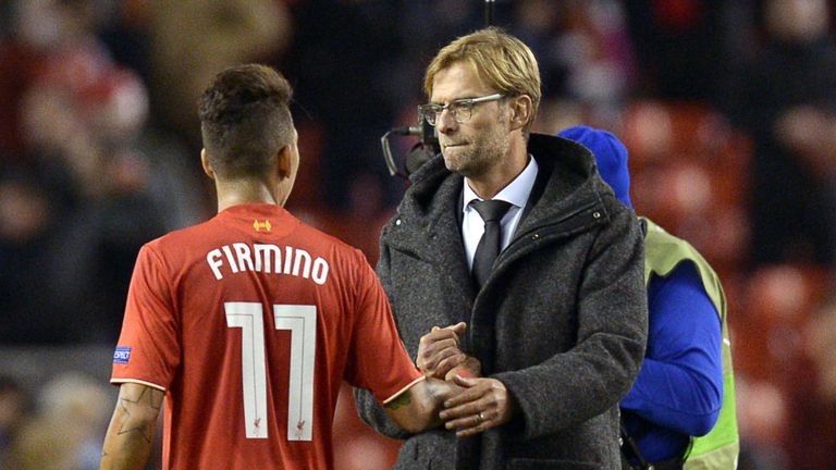 Liverpool's Jurgen Klopp (R) shakes hands with Roberto Firmino